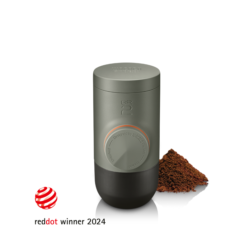 MINIPRESSO GR2 compact design with coffee grounds showcasing its innovative espresso brewing.
