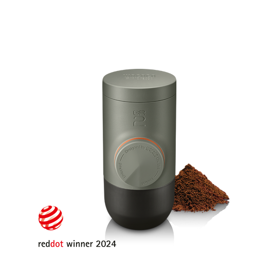 MINIPRESSO GR2 compact design with coffee grounds showcasing its innovative espresso brewing.